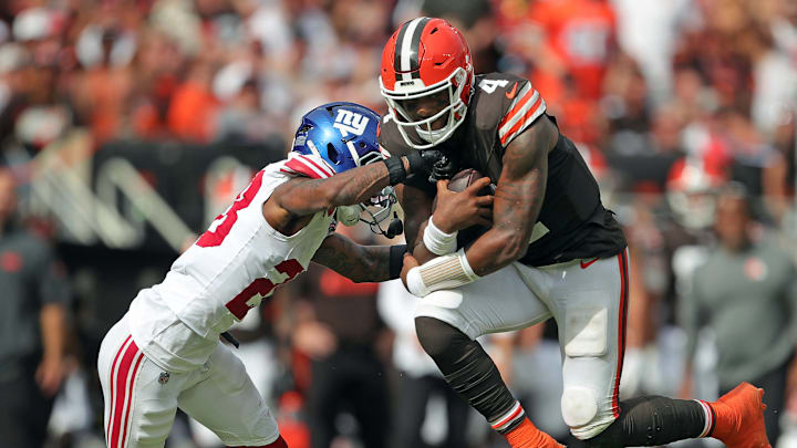 Cleveland Browns quarterback Deshaun Watson (4) hops past New York Giants cornerback Cor'Dale Flott (28) on his way to a first down during the second half of an NFL football game at Huntington Bank Field, Sunday, Sept. 22, 2024, in Cleveland, Ohio. Cleveland Browns quarterback Deshaun Watson (4) hops past New York Giants cornerback Cor'Dale Flott (28) on his way to a first down during the second half of an NFL football game at Huntington Bank Field, Sunday, Sept. 22, 2024, in Cleveland, Ohio.