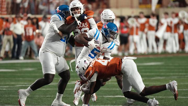 Oct 24, 2026; Austin, Texas, USA;  Mississippi Rebels running back Kewan Lacy (5) is tackled by Texas Longhorns defensive back Jelani McDonald (4) during the first half at Darrell K Royal-Texas Memorial Stadium.  Mandatory Credit: Scott Wachter-Imagn Images