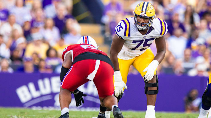Sep 6, 2025; Baton Rouge, Louisiana, USA; LSU Tigers offensive tackle Weston Davis (75) lines up against Louisiana Tech Bulldogs defensive lineman Jayden Madkins (90) during the first half against Louisiana Tech Bulldogs at Tiger Stadium. Mandatory Credit: Stephen Lew-Imagn Images Sep 6, 2025; Baton Rouge, Louisiana, USA; LSU Tigers offensive tackle Weston Davis (75) lines up against Louisiana Tech Bulldogs defensive lineman Jayden Madkins (90) during the first half against Louisiana Tech Bulldogs at Tiger Stadium. Mandatory Credit: Stephen Lew-Imagn Images