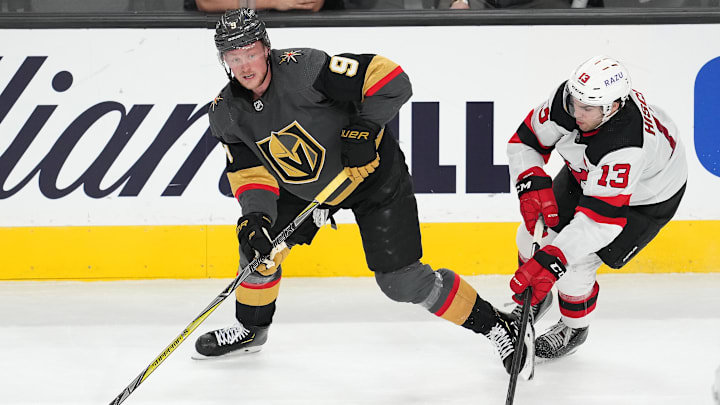 Vegas Golden Knights center Jack Eichel (9) looks to make a pass as New Jersey Devils center Nico Hischier (13) defends. Mandatory Credit: Stephen R. Sylvanie-Imagn Images