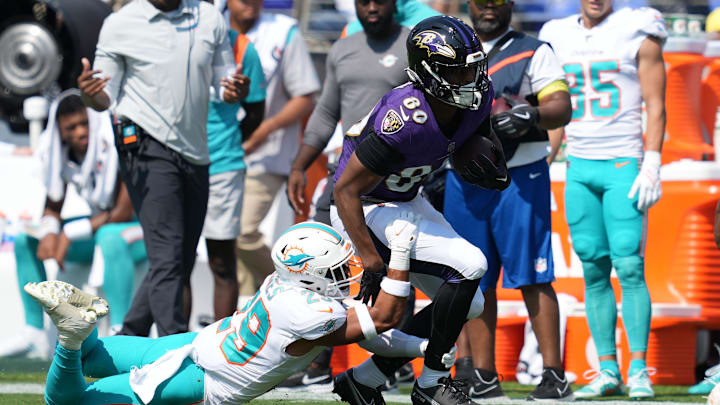 Baltimore Ravens tight end Isaiah Likely (80) is defended after a catch by Miami Dolphins safety Brandon Jones (29) at M&T Bank Stadium in a 2022 game.