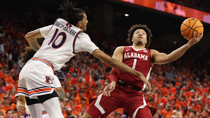 Feb 7, 2024; Auburn, Alabama, USA; Alabama Crimson Tide guard Mark Sears (1) takes a shot as Auburn Tigers guard Chad Baker-Mazara (10) defends during the first half at Neville Arena. Mandatory Credit: John Reed-Imagn Images