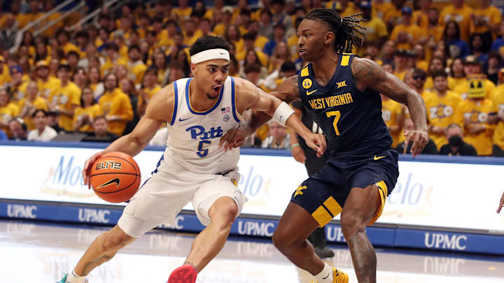 Nov 15, 2024; Pittsburgh, Pennsylvania, USA;  Pittsburgh Panthers guard Ishmael Leggett (5) drives to the basket against West Virginia Mountaineers guard Javon Small (7) during the first half at the Petersen Events Center. Mandatory Credit: Charles LeClaire-Imagn Images