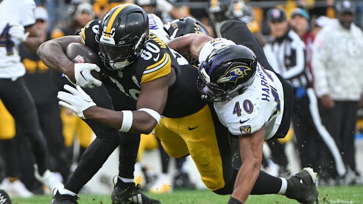 Nov 17, 2024; Pittsburgh, Pennsylvania, USA; Pittsburgh Steelers tight end Darnell Washington (80) dives for extra yardage while being tackled by Baltimore Ravens linebacker Malik Harrison (40) during the fourth quarter at Acrisure Stadium. Mandatory Credit: Barry Reeger-Imagn Images