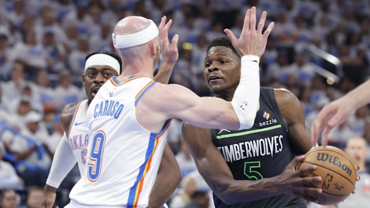 May 20, 2025; Oklahoma City, Oklahoma, USA; Minnesota Timberwolves guard Anthony Edwards (5) drives against Oklahoma City Thunder guard Alex Caruso (9) in the second quarter during game one of the western conference finals for the 2025 NBA Playoffs at Paycom Center. Mandatory Credit: Alonzo Adams-Imagn Images