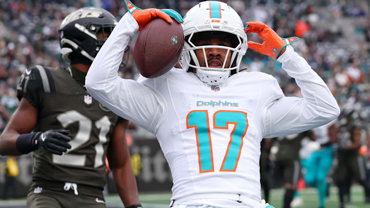 Dec 7, 2025; East Rutherford, New Jersey, USA; Miami Dolphins wide receiver Jaylen Waddle (17) reacts after making a catch for a touchdown against the New York Jets during the first half at MetLife Stadium. Mandatory Credit: Ed Mulholland-Imagn Images