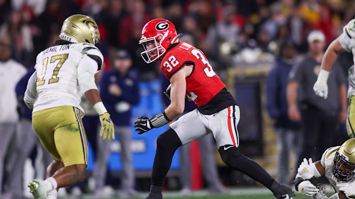 Nov 29, 2024; Athens, Georgia, USA; Georgia Bulldogs running back Cash Jones (32) runs the ball against the Georgia Tech Yellow Jackets in the fourth quarter at Sanford Stadium. Mandatory Credit: Brett Davis-Imagn Images
