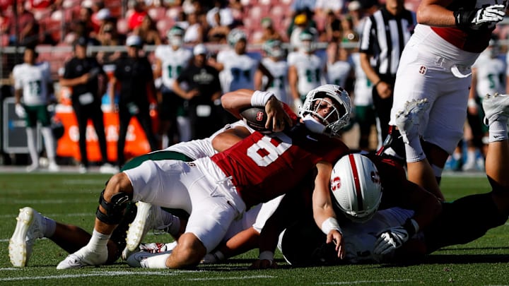 Sep 7, 2024; Stanford, California, USA; Stanford Cardinal quarterback Justin Lamson (8) is tackled by Cal Poly Mustangs defensive lineman Mason Barbour (96) during the second quarter at Stanford Stadium. Mandatory Credit: Sergio Estrada-Imagn Images