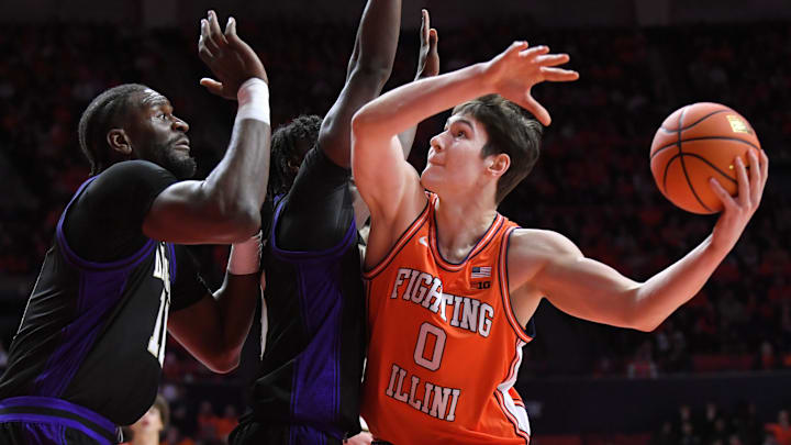 Jan 29, 2026; Champaign, Illinois, USA;  Illinois Fighting Illini forward David Mirkovic (0) drives to the basket as Washington Huskies center Franck Kepnang (11) defends during the first half at State Farm Center. Mandatory Credit: Ron Johnson-Imagn Images