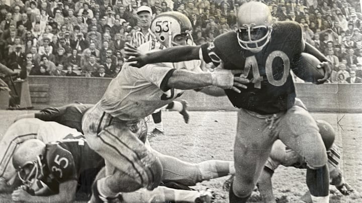 Donnie Moore runs through an Ohio State tackle in 1965 at Husky Stadium. 