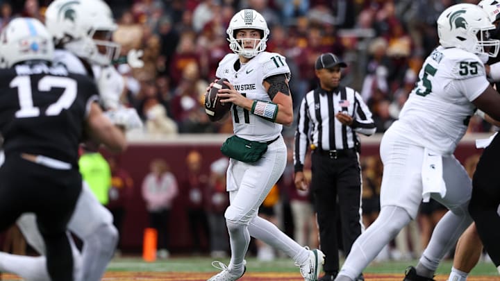 Nov 1, 2025; Minneapolis, Minnesota, USA; Michigan State Spartans quarterback Alessio Milivojevic (11) looks to pass against the Minnesota Golden Gophers during the first half at Huntington Bank Stadium. Mandatory Credit: Matt Krohn-Imagn Images Nov 1, 2025; Minneapolis, Minnesota, USA; Michigan State Spartans quarterback Alessio Milivojevic (11) looks to pass against the Minnesota Golden Gophers during the first half at Huntington Bank Stadium. Mandatory Credit: Matt Krohn-Imagn Images