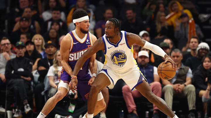 Dec 12, 2023; Phoenix, Arizona, USA; Golden State Warriors forward Jonathan Kuminga (00) against Phoenix Suns guard Devin Booker (1) at Footprint Center. Mandatory Credit: Mark J. Rebilas-Imagn Images Dec 12, 2023; Phoenix, Arizona, USA; Golden State Warriors forward Jonathan Kuminga (00) against Phoenix Suns guard Devin Booker (1) at Footprint Center. Mandatory Credit: Mark J. Rebilas-Imagn Images