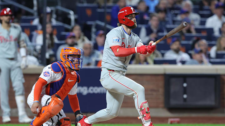Oct 9, 2024; New York, New York, USA; Philadelphia Phillies first baseman Bryce Harper (3) hits a double in the sixth inning against the New York Mets in game four of the NLDS for the 2024 MLB Playoffs at Citi Field. 