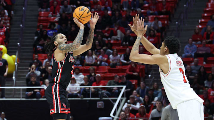 Feb 10, 2026; Salt Lake City, Utah, USA; Houston Cougars guard Emanuel Sharp (21) goes up for a three-point shot against Utah Utes forward Josh Hayes (7) during the first half at Jon M. Huntsman Center. Mandatory Credit: Rob Gray-Imagn Images