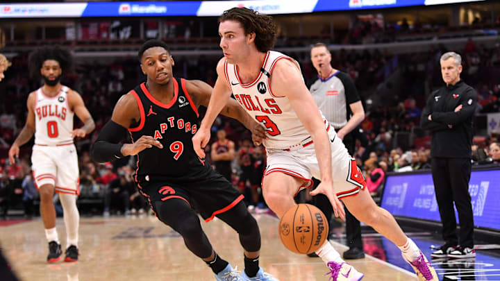 Feb 28, 2025; Chicago, Illinois, USA; Chicago Bulls guard Josh Giddey (3) drives against Toronto Raptors guard RJ Barrett (9) during a game at the United Center. Mandatory Credit: Patrick Gorski-Imagn Images