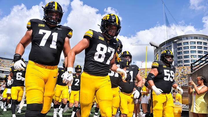 Sep 5, 2026; Iowa City, Iowa, USA;  Iowa Hawkeyes offensive lineman Jack Dotzler (71) and tight end Addison Ostrenga (87) and offensive lineman Trevor Lauck (59) come off the field before the game against the Northern Illinois Huskies at Kinnick Stadium.  Mandatory Credit: Jeffrey Becker-Imagn Images