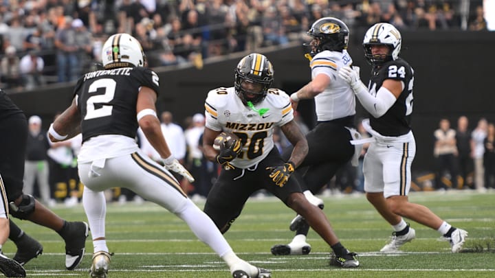 Oct 25, 2025; Nashville, Tennessee, USA; Missouri Tigers running back Jamal Roberts (20) runs the ball while defended by Vanderbilt Commodores safety Randon Fontenette (2) during the third quarter at FirstBank Stadium. Mandatory Credit: Steve Roberts-Imagn Images