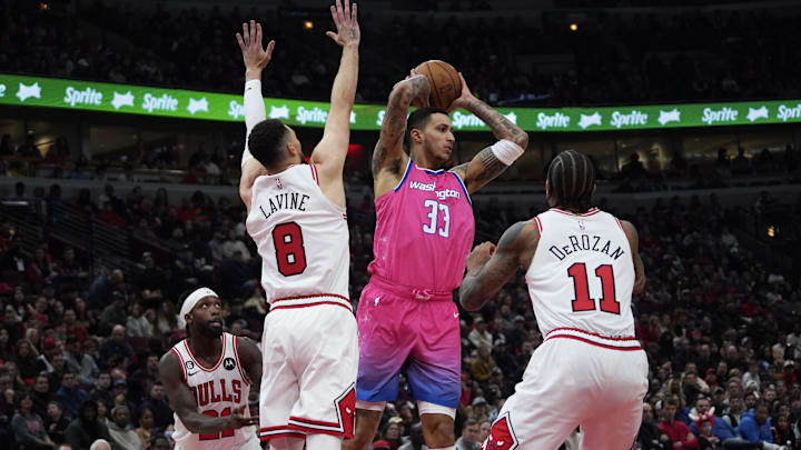 Feb 26, 2023; Chicago, Illinois, USA; Chicago Bulls guard Zach LaVine (8) and forward DeMar DeRozan (11) defend Washington Wizards forward Kyle Kuzma (33) during the first half at United Center. Mandatory Credit: David Banks-USA TODAY Sports