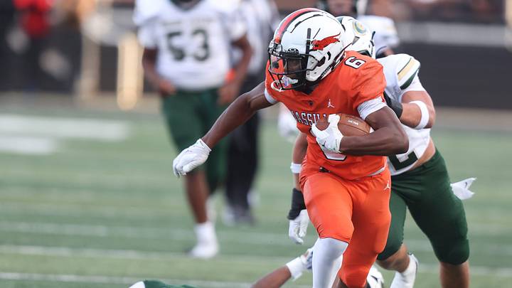 Massillon's Deontay Malone pulls away from the GlenOak defense during a high school football game at Paul Brown Tiger Stadium in Massillon Friday, August 29, 2025.