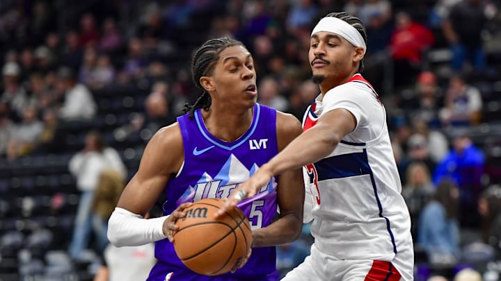 Mar 19, 2025; Salt Lake City, Utah, USA;  Washington Wizards guard Jordan Poole (13) makes steal attempt against Utah Jazz forward Cody Williams (5) during the second half at the Delta Center. Mandatory Credit: Peter Creveling-Imagn Images