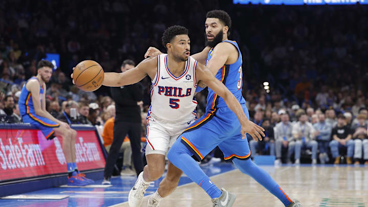 Mar 19, 2025; Oklahoma City, Oklahoma, USA; Philadelphia 76ers guard Quentin Grimes (5) drives as Oklahoma City Thunder forward Kenrich Williams (34) defends the play during the second quarter at Paycom Center. Mandatory Credit: Alonzo Adams-Imagn Images