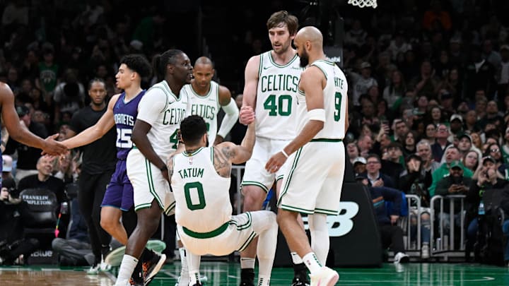 Apr 11, 2025; Boston, Massachusetts, USA; Boston Celtics guard Jrue Holiday (4) and .center Luke Kornet (40) help forward Jayson Tatum (0) to his feet during the second half against the Charlotte Hornets at TD Garden. Mandatory Credit: Eric Canha-Imagn Images
