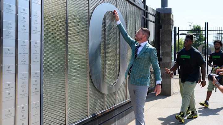 Aug 31, 2024; Eugene, Oregon, USA; Oregon Ducks head coach Dan Lanning touches the O logo before the game against the Idaho Vandals at Autzen Stadium. Mandatory Credit: Craig Strobeck-Imagn Images