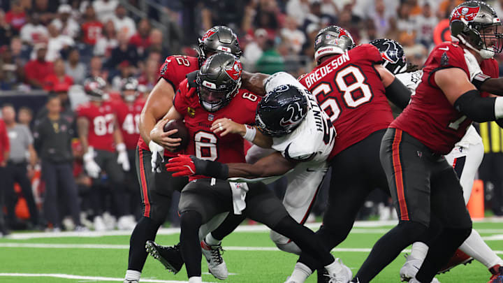 Sep 15, 2025; Houston, Texas, USA; Tampa Bay Buccaneers quarterback Baker Mayfield (6) is sacked by Houston Texans defensive end Danielle Hunter (55) during the second quarter at NRG Stadium. Mandatory Credit: Thomas Shea-Imagn Images