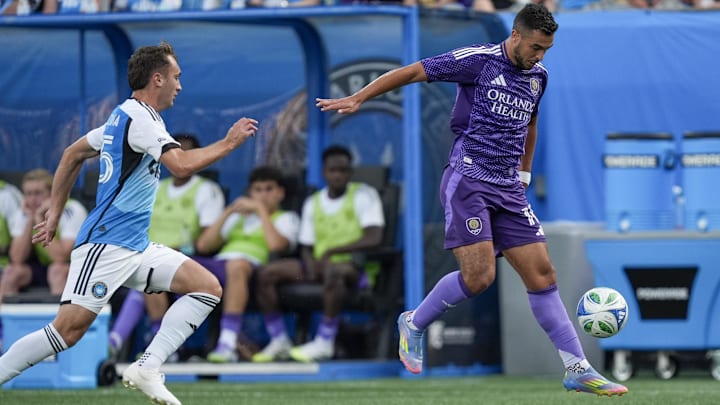 Jul 5, 2025; Charlotte, North Carolina, USA; Orlando City midfielder Martin Ojeda (10) controls the ball as Charlotte FC midfielder Nick Scardina (35) defends during the first half at Bank of America Stadium. Mandatory Credit: Jim Dedmon-Imagn Images