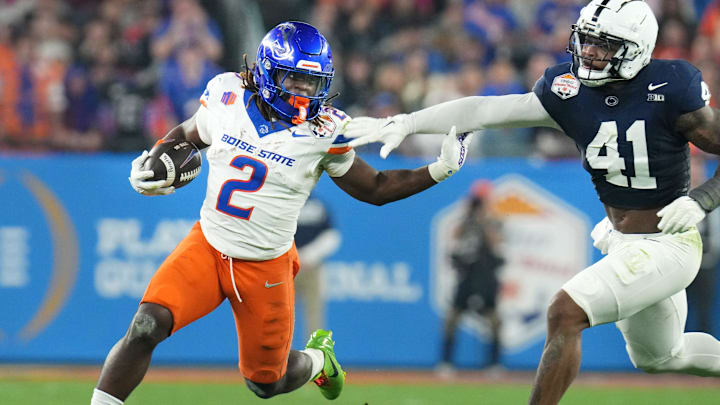 Boise State Broncos running back Ashton Jeanty (2) runs past Penn State Nittany Lions linebacker Kobe King (41) during their Vrbo Fiesta Bowl matchup at State Farm Stadium on Dec. 31, 2024. Boise State Broncos running back Ashton Jeanty (2) runs past Penn State Nittany Lions linebacker Kobe King (41) during their Vrbo Fiesta Bowl matchup at State Farm Stadium on Dec. 31, 2024.