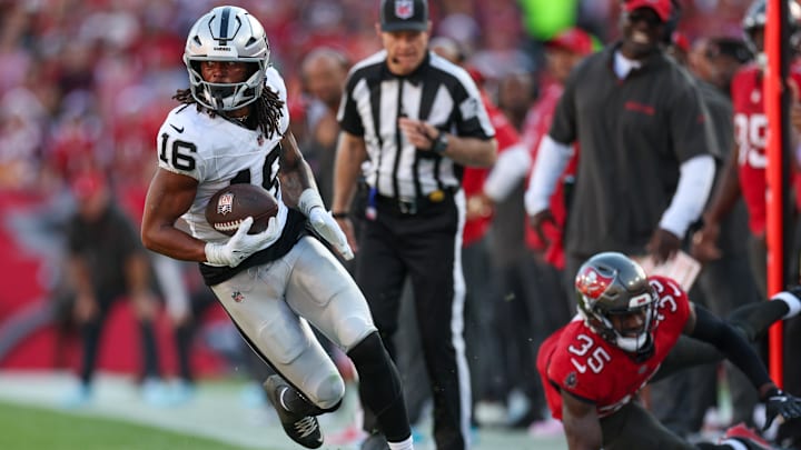 Dec 8, 2024; Tampa, Florida, USA; Las Vegas Raiders wide receiver Jakobi Meyers (16) runs with the ball against the Tampa Bay Buccaneers in the fourth quarter at Raymond James Stadium. Mandatory Credit: Nathan Ray Seebeck-Imagn Images