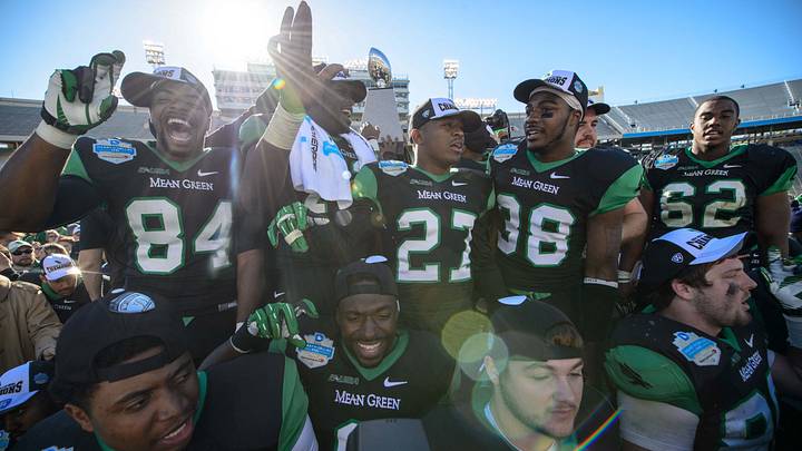 Jan 1, 2014; Dallas, TX, USA; The North Texas Mean Green celebrate the win over the UNLV Rebels at the Cotton Bowl Stadium. The Mean Green defeated the Rebels 36-14. Mandatory Credit: Jerome Miron-USA TODAY Sports Jan 1, 2014; Dallas, TX, USA; The North Texas Mean Green celebrate the win over the UNLV Rebels at the Cotton Bowl Stadium. The Mean Green defeated the Rebels 36-14. Mandatory Credit: Jerome Miron-USA TODAY Sports