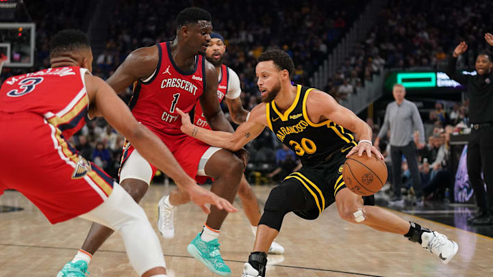 Jan 10, 2024; San Francisco, California, USA; Golden State Warriors guard Stephen Curry (30) dribbles the ball next to New Orleans Pelicans forward Zion Williamson (1) in the second quarter at the Chase Center. Mandatory Credit: Cary Edmondson-Imagn Images