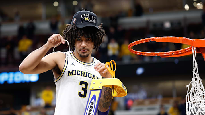 Mar 29, 2026; Chicago, IL, USA; Michigan Wolverines guard Elliot Cadeau (3) cuts the net after defeating Tennessee Volunteers in an Elite Eight game of the Midwest Regional of the men's 2026 NCAA Tournament at United Center. Mandatory Credit: Kamil Krzaczynski-Imagn Images