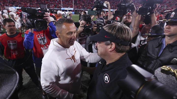 Nov 15, 2025; Athens, Georgia, USA; Texas Longhorns head coach Steve Sarkisian and Georgia Bulldogs head coach Kirby Smart interact after a game at Sanford Stadium. Mandatory Credit: Brett Davis-Imagn Images