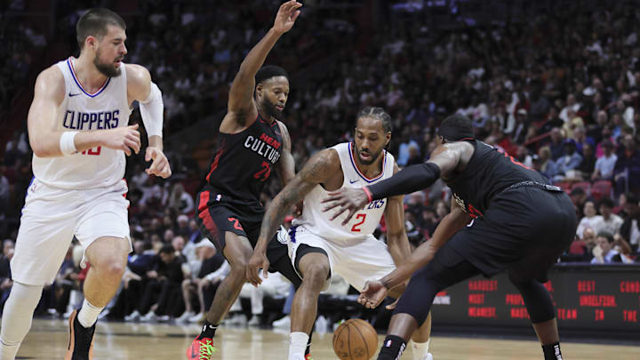 LA Clippers forward Kawhi Leonard (2) protects the basketball from Miami Heat forward Haywood Highsmith (24) and center Bam Adebayo (13) during the third quarter at Kaseya Center. Mandatory Credit: Sam Navarro-Imagn Images