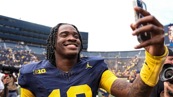 Michigan quarterback Bryce Underwood (19) records a video to celebrate 63-3 win over Central Michigan as he exits the field at Michigan Stadium in Ann Arbor on Saturday, Sept. 13, 2025.