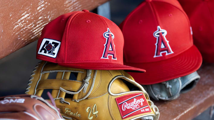 Feb 28, 2025; Phoenix, Arizona, USA; Detailed view of the Los Angeles Angels logo on a hat in the dugout during a spring training game at Camelback Ranch-Glendale. Mandatory Credit: Mark J. Rebilas-Imagn Images