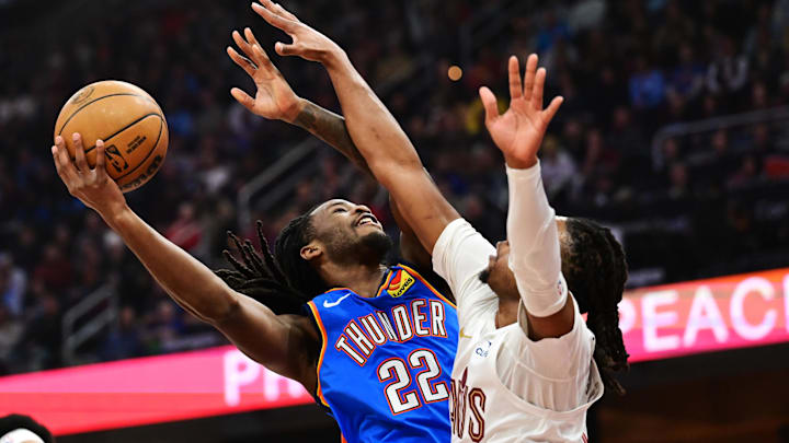Jan 8, 2025; Cleveland, Ohio, USA; Oklahoma City Thunder guard Cason Wallace (22) drives to the basket against Cleveland Cavaliers guard Darius Garland (10) during the first quarter at Rocket Mortgage FieldHouse. Mandatory Credit: Ken Blaze-Imagn Images