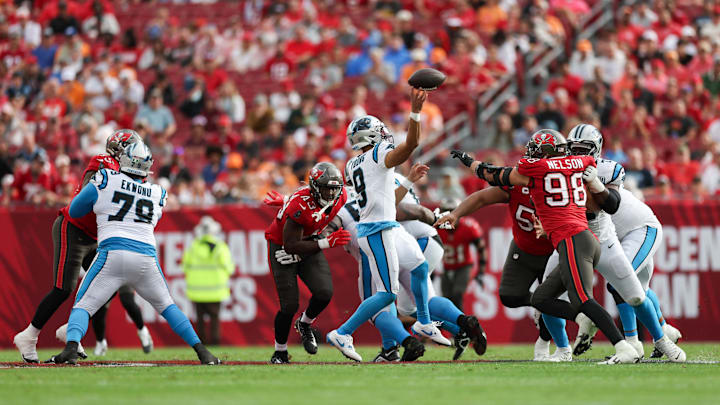 Dec 29, 2024; Tampa, Florida, USA; Carolina Panthers quarterback Bryce Young (9) is pressured by Tampa Bay Buccaneers linebacker Anthony Nelson (98) in the fourth quarter at Raymond James Stadium. Mandatory Credit: Nathan Ray Seebeck-Imagn Images