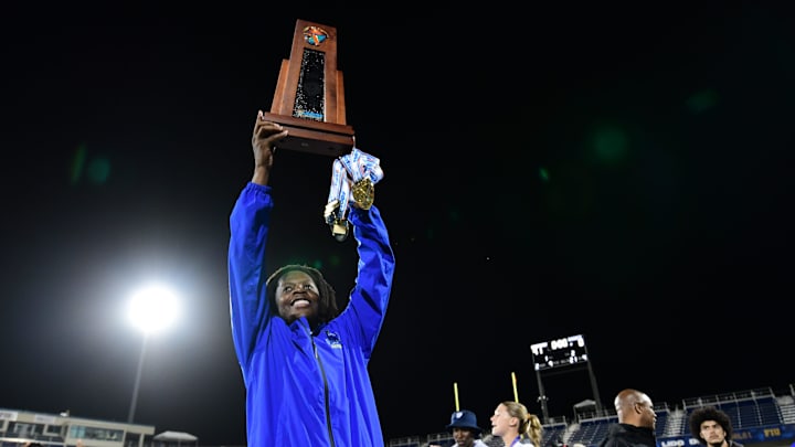 Miami Northwestern's Teddy Bridgewater raises the state trophy following the team's win over Raines in the Class 3A championship on Dec. 14, 2024.