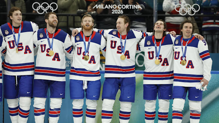 Feb 22, 2026; Milan, Italy; United States players including Jack Hughes (86) of the United States celebrate with their gold medals after defeating Canada in the men's ice hockey gold medal game during the Milano Cortina 2026 Olympic Winter Games at Milano Santagiulia Ice Hockey Arena. Mandatory Credit: Geoff Burke-Imagn Images