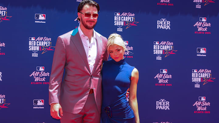 National League pitcher Paul Skenes (30) of the Pittsburgh Pirates and social media influencer Livvy Dunne pose for a photo on the red carpet before the 2025 MLB All Star Game at Truist Park.