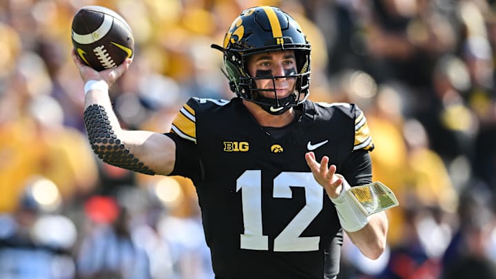 Oct 12, 2024; Iowa City, Iowa, USA; Iowa Hawkeyes quarterback Cade McNamara (12) throws a pass against the Washington Huskies during the first quarter at Kinnick Stadium. Mandatory Credit: Jeffrey Becker-Imagn Images