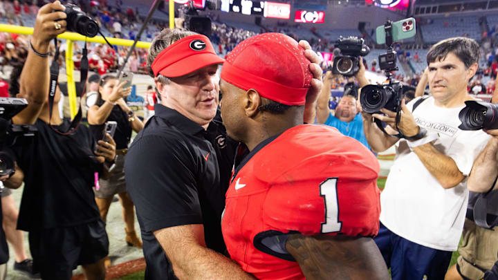 Georgia Bulldogs head coach Kirby Smart gives Georgia Bulldogs running back Trevor Etienne (1) a hug after the Bulldogs defeated the Gators at EverBank Stadium in Jacksonville, FL on Saturday, November 2, 2024. The Bulldogs defeated the Gators 34-20. [Doug Engle/Gainesville Sun]