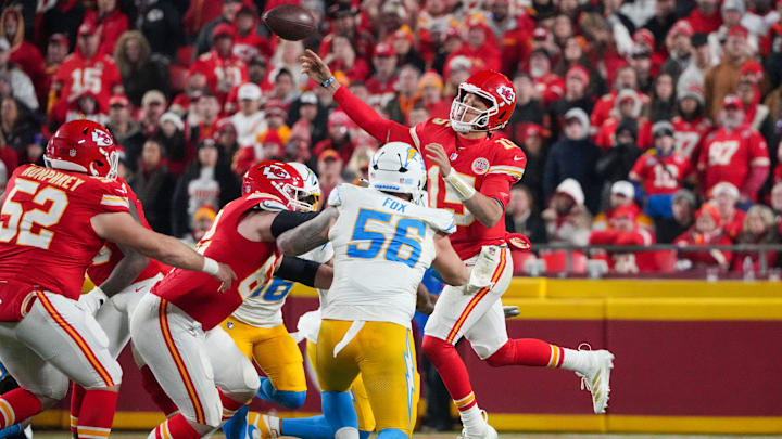 Dec 8, 2024; Kansas City, Missouri, USA; Kansas City Chiefs quarterback Patrick Mahomes (15) leaps while passing as Los Angeles Chargers defensive end Morgan Fox (56) defends during the second half at GEHA Field at Arrowhead Stadium. Mandatory Credit: Denny Medley-Imagn Images
