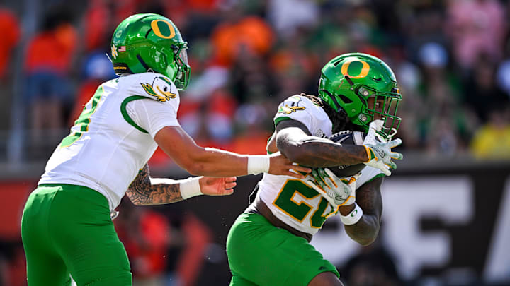 Oregon Ducks quarterback Dillon Gabriel (8) hands off the ball to Oregon Ducks running back Jordan James (20) during the annual rivalry game against the Oregon State Beavers on Saturday, Sept. 14, 2024, at Reser Stadium in Corvallis, Ore.