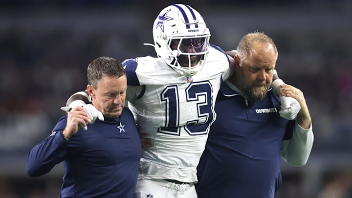 Dallas Cowboys linebacker DeMarvion Overshown is helped off the field after an injury in the second half against the Cincinnati Bengals.