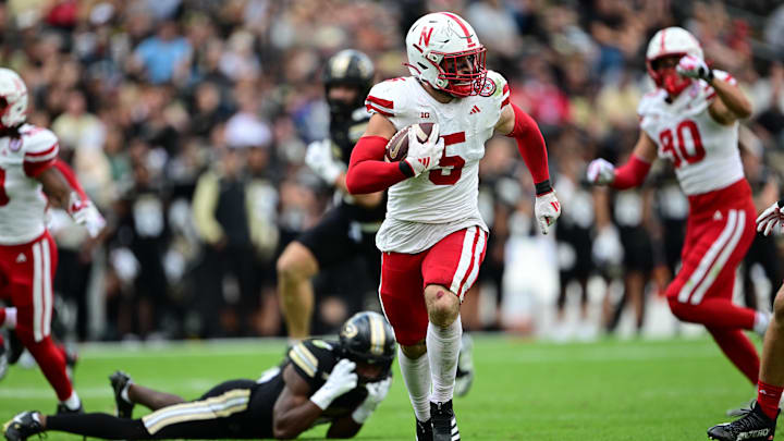 Sep 28, 2024; West Lafayette, Indiana, USA; Nebraska Cornhuskers linebacker John Bullock (5) runs the ball for a touchdown after an interception against the Purdue Boilermakers during the second half at Ross-Ade Stadium. 
