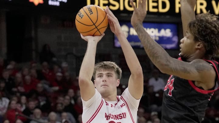 Wisconsin forward Nolan Winter (31) hits a three-point basket s Ball State forward Mason Jones (24) defends during the second half of their game Tuesday, November 11, 2025 at the Kohl Center in Madison, Wisconsin. Wisconsin beat Ball State 86-55.